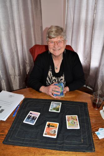 Tarot card reader at Mouzon with cards laid out in front of her