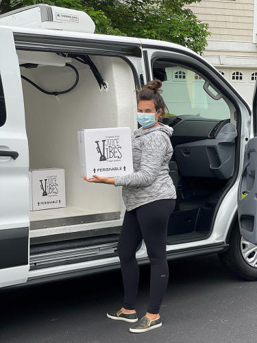 JuiceVibes to go kits being loaded in a van to deliver.