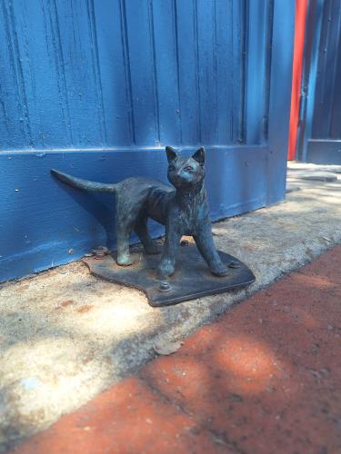 Cat sculpture sitting on the pavement