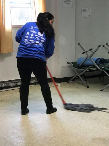 Volunteer mopping floor