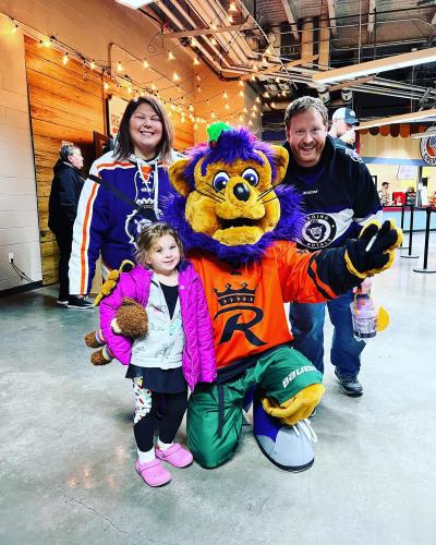 Family poses with slapshot the reading royals mascot
