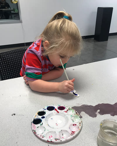 A child painting at the Prairie Arts Center