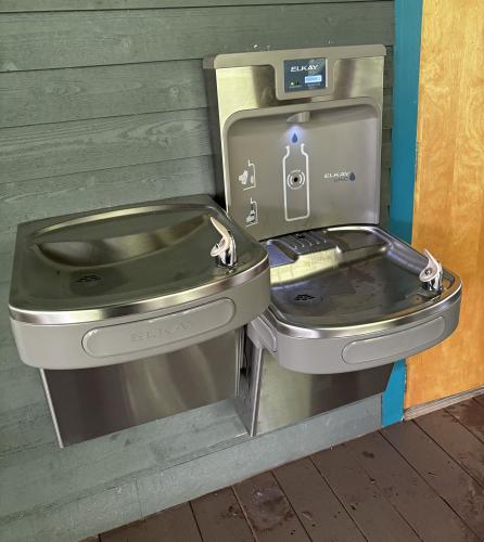 Public water fountains beside the restrooms at the Visit The Northshore Visitor Center include a bottle-filling station with a counter tracking plastic bottles saved from landfills.
