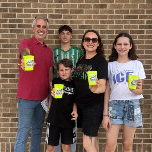 Family posing for a photo enjoying lemonade at Christmas in July