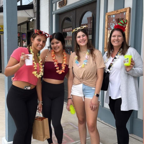 Four women enjoying downtown during Christmas in July