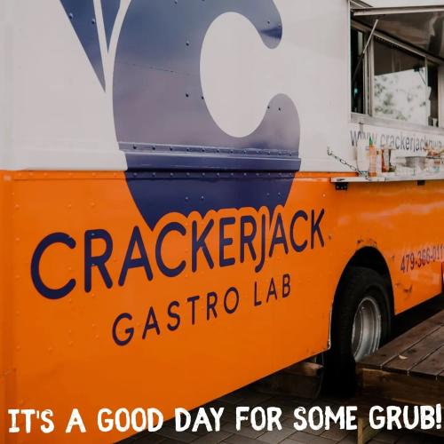 The exterior of Crackerjack Gastro Lab food truck is orange on the bottom half and white on the top half.