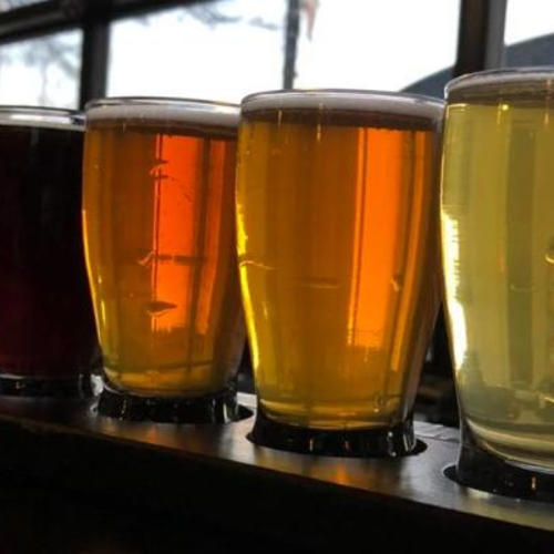 A flight of beers from Freedom's Edge Brewery in Cheyenne, Wyoming, backlit by the glass garage door