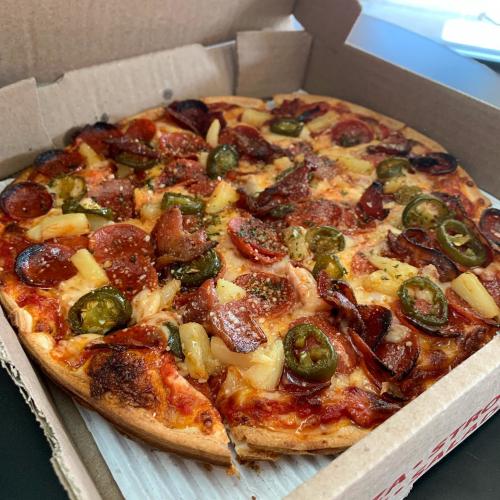 an open pizza box from Carlucci's Pizzaria