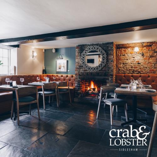 A cosy fire and tables at the Crab & Lobster, Sidlesham, West Sussex