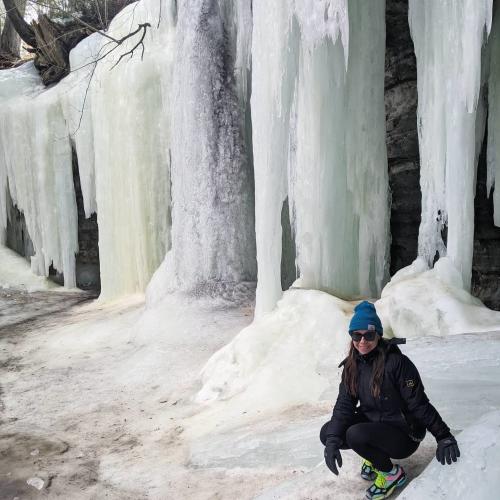 Woman posing in front of the Eben Ice Caves located in Michigan's Upper Peninsula, USA