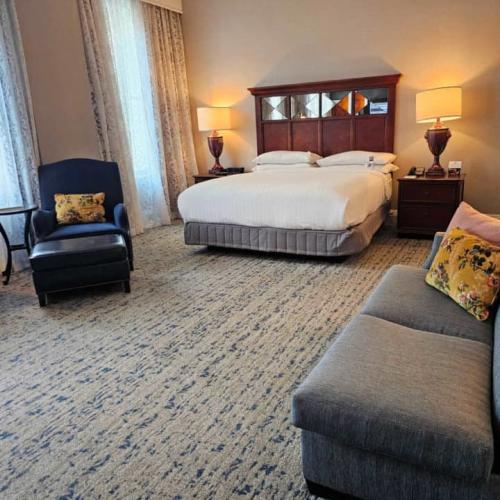 Hotel room with king bed, chaise lounge and love seat