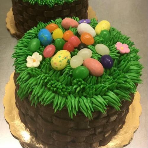 Chocolate basket weave cake with Easter eggs and fake grass on top