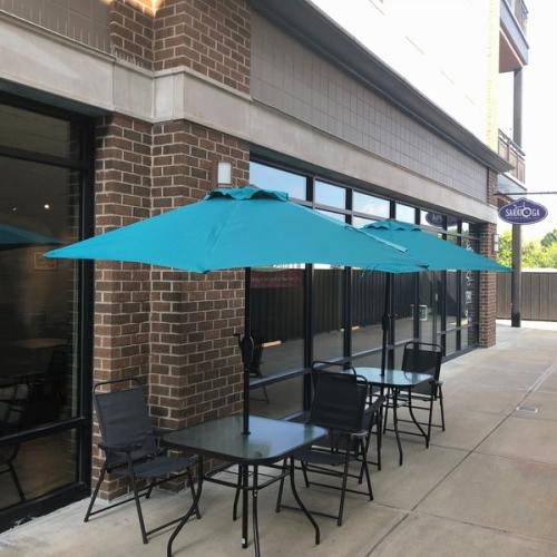 two patio tables outside of Saratoga Broadway Deli in Saratoga Springs