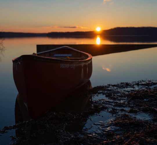 A canoe on Monroe Lake at sunset