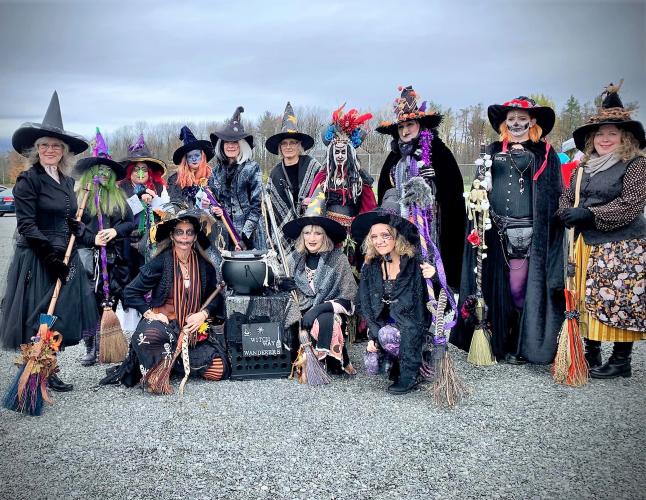 Large group of witches posing against a gray background