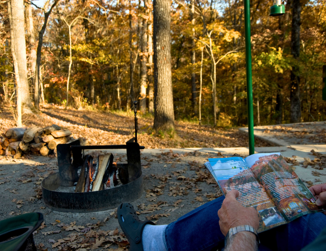 Campers enjoy a fall bonfire at Lake Fort Smith State Park.