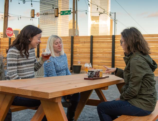 3 people drinking outside at Angry Scotsman