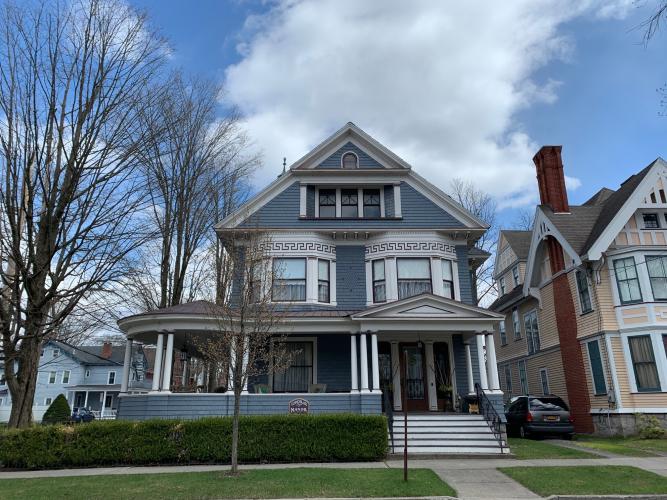 Blue Victorian home with large wraparound porch