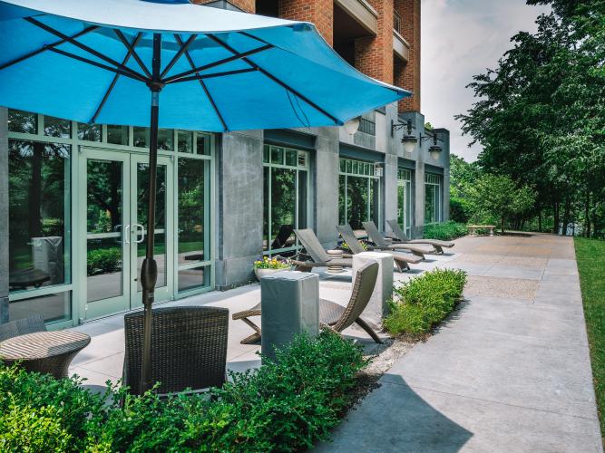 Empty patio with blue umbrella on a sunny day at Complexions in Saratoga Springs, NY