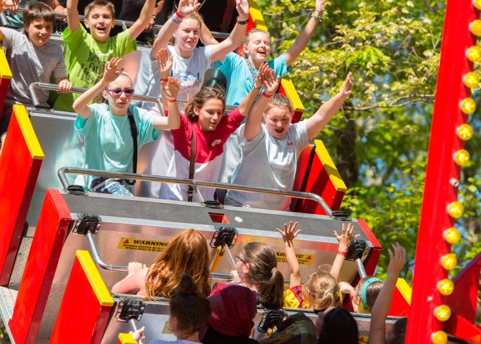 Kids thrilled on Lemonade Days roller coaster, enjoying carnival atmosphere in Dunwoody