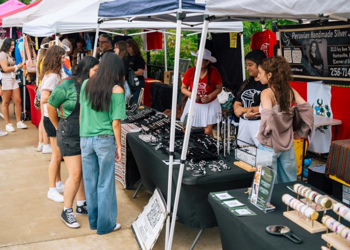Attendees browse handmade jewelry and other vendor booths during the CulturA Festival at The Orion Amphitheater in Huntsville.
