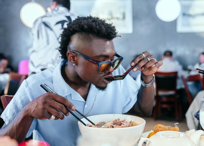 A man eating a bowl of food at Golden Phoenix