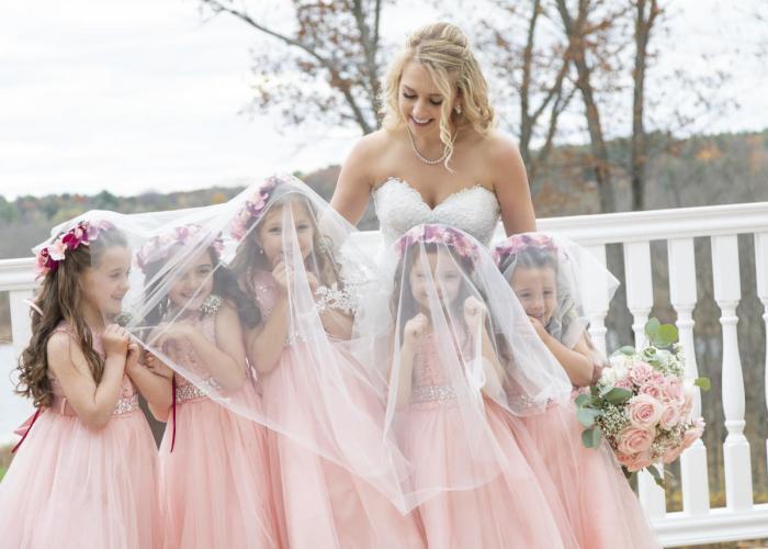 Bride with three young bridesmaids dressed in pink