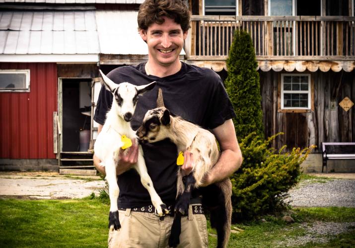 Man holding baby goat