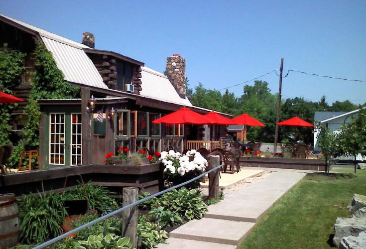 Omalley's cabin exterior with outdoor tables and red awnings
