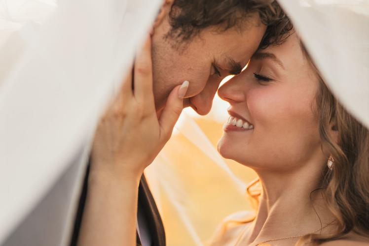 married couple w/ veil at golden hour