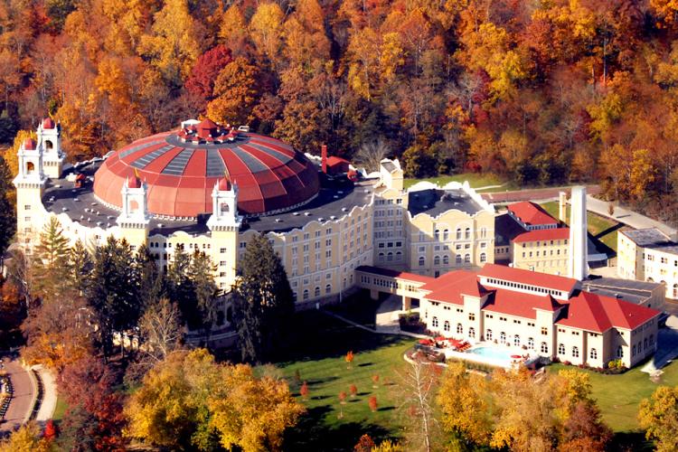 An aerial view of the domed roof of the West Baden Springs Hotel with autumn foliage on the trees