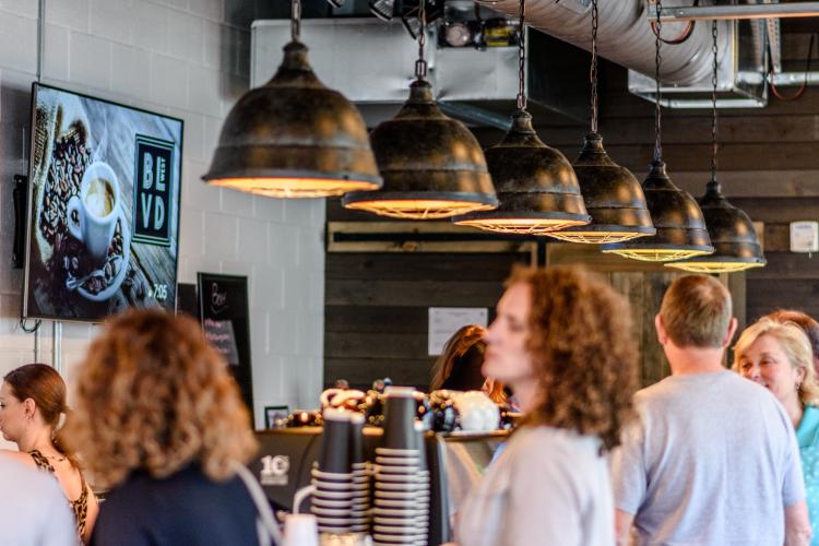 Customers ordering drinks inside Boulevard West, a coffee shop and bar in Clayton, NC.