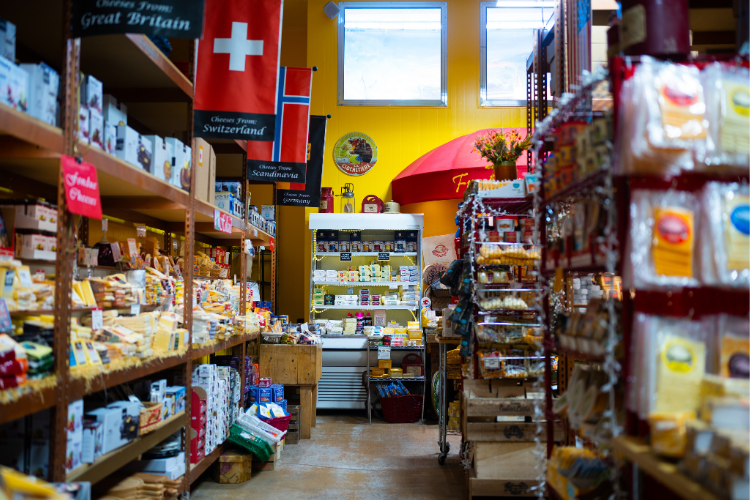 Aisle of many types of Cheese at Cheese Importers
