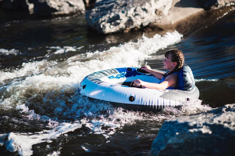 Young person tubing at Dicken's Farm