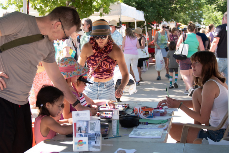 Families checking out a booth at the Longmont Farmer's Market