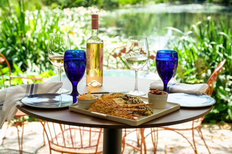 Beautiful Table set up with Blue water glasses and a bottle of white wine