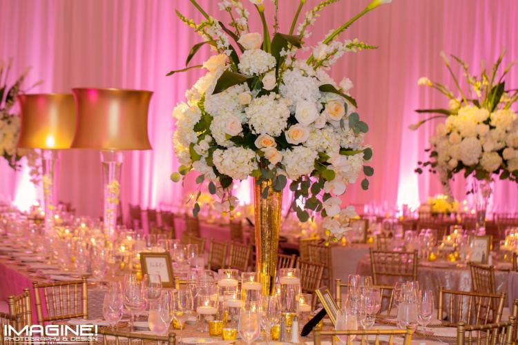 Karen & Company Event Planning reception table setting with large floral centerpieces and pink background draping