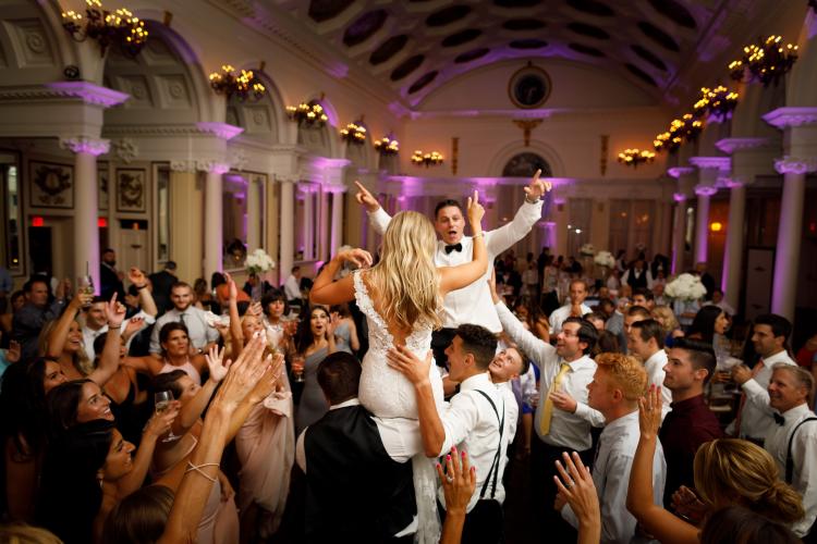 Reception in Hall of Springs with bride and groom on guests' shoulders