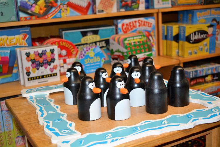 Set of toy penguins on table inside store