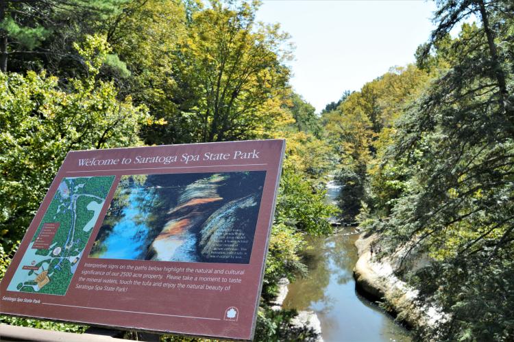 Welcome sign overlooking Geyser Creek taken from the bridge going into SPAC
