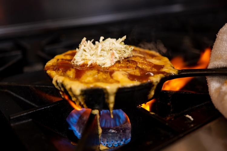 Mac and cheese in small cast iron skiller over gas burner