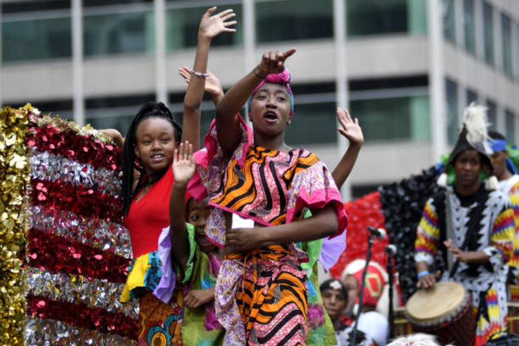 Two African American women celebrating Juneteenth on a parade float