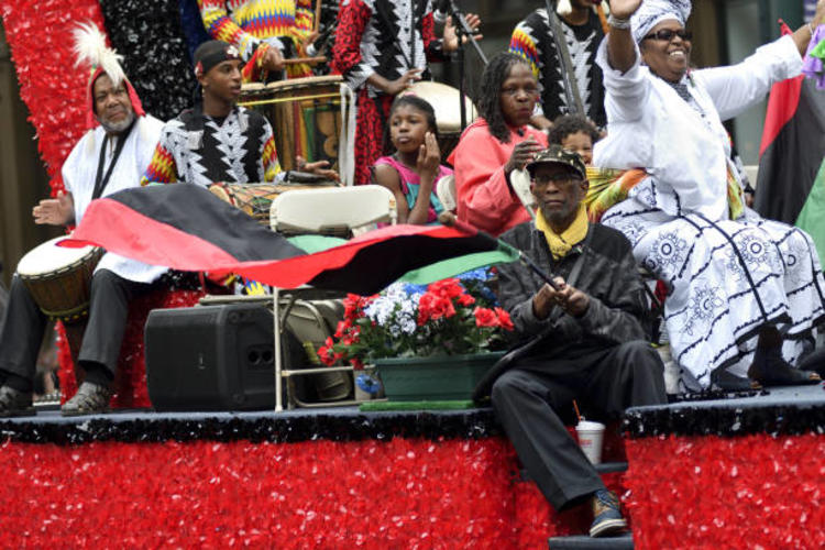 People sitting on a red parade float