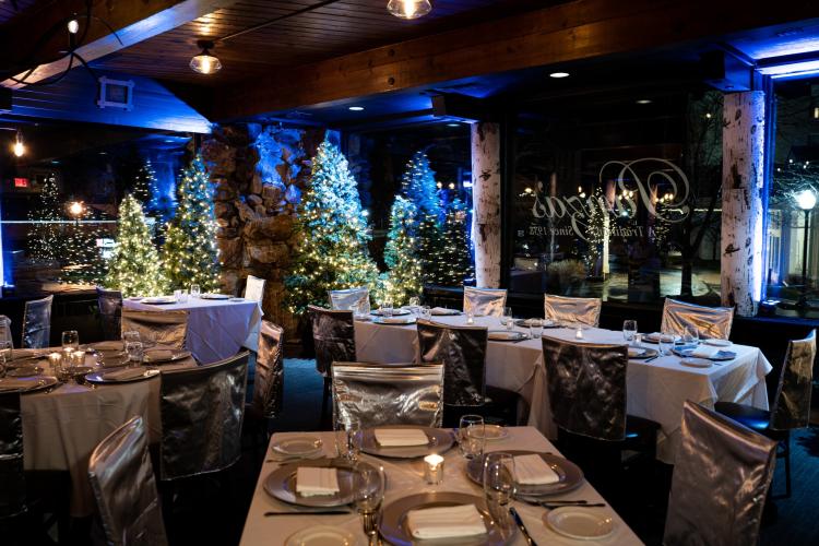 Panza's dining room decorated with multiple Christmas trees