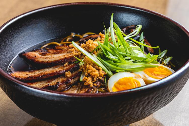 Black wooden bowl with porkbelly ramen