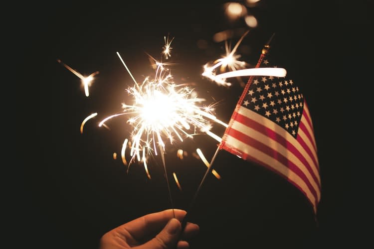 A firework sparkler and American flag