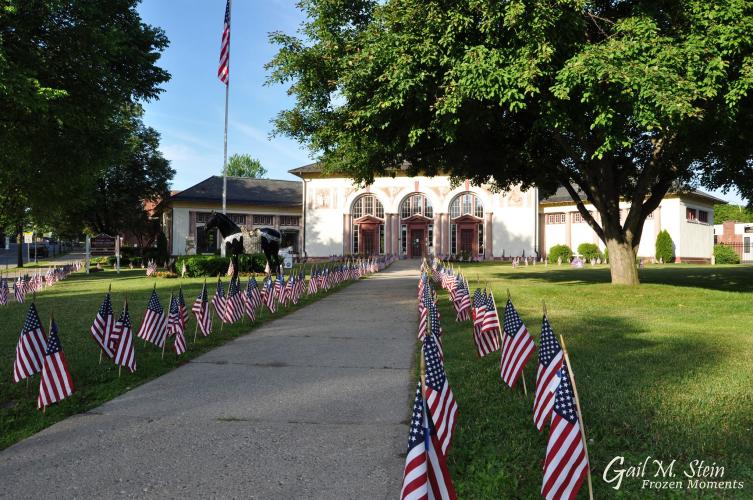 Saratoga Springs Visitor Center with rows of flags in the front