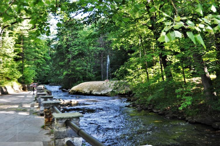 Geyser Creek with trail running alongside and shooter in the distance