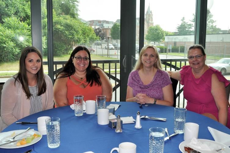 A shot of four attendees seated after breakfast