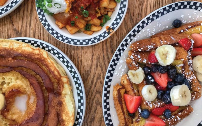 Three breakfast dishes on a table at The Village Deli